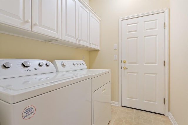 311 Dove Hollow Trl, Georgetown, TX 78633 - laundry room with washer and clothes dryer, cabinet space, baseboards, and light tile patterned floors