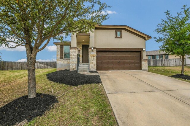 5741 Porano Cir, Round Rock, TX 78665 - view of front of home with stone siding, stucco siding, driveway, and an attached garage