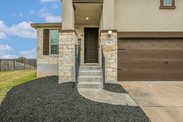5741 Porano Cir, Round Rock, TX 78665 - doorway to property with stone siding, a garage, and stucco siding