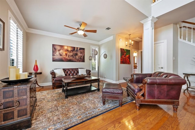 6425 Yaupon Dr, Austin, TX 78759 - living room featuring hardwood / wood-style floors, a ceiling fan, ornate columns, crown molding, and a chandelier