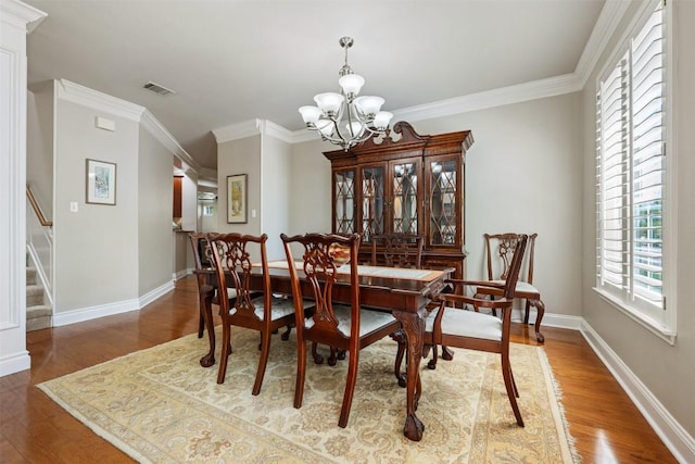6425 Yaupon Dr, Austin, TX 78759 - dining space with a chandelier, wood finished floors, stairway, and ornamental molding
