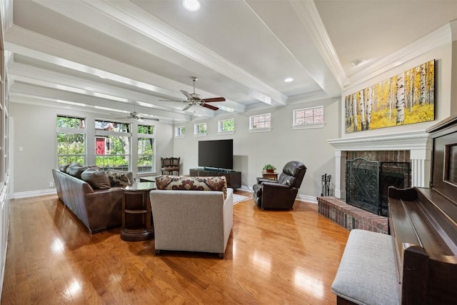 6425 Yaupon Dr, Austin, TX 78759 - living area with ceiling fan, light wood-style flooring, beamed ceiling, a fireplace, and crown molding