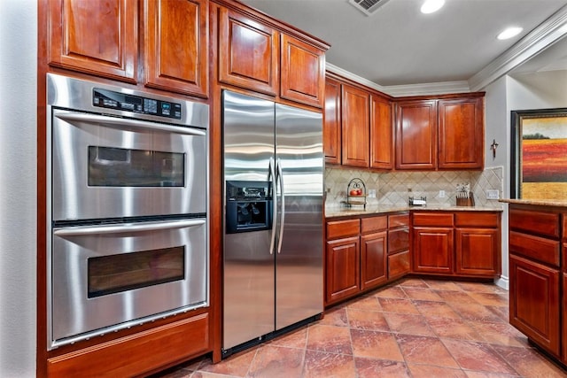 6425 Yaupon Dr, Austin, TX 78759 - kitchen featuring appliances with stainless steel finishes, backsplash, light stone counters, ornamental molding, and brown cabinetry