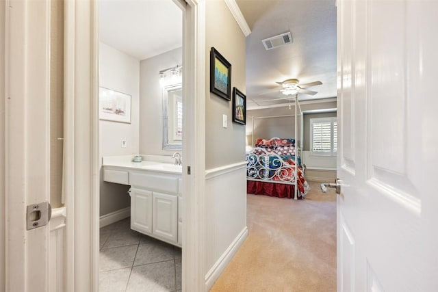 6425 Yaupon Dr, Austin, TX 78759 - bedroom with crown molding, light carpet, and light tile patterned floors