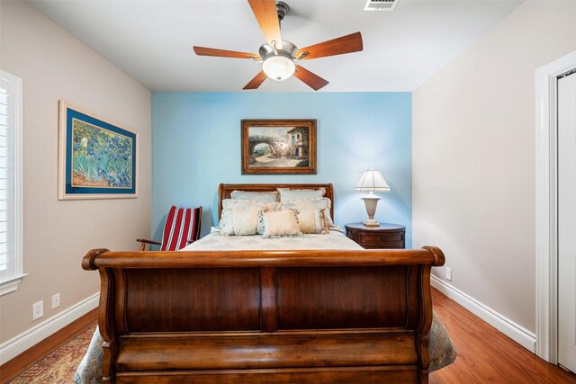 6425 Yaupon Dr, Austin, TX 78759 - bedroom featuring wood finished floors and ceiling fan