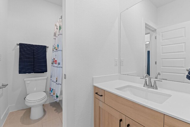 full bathroom with tile patterned flooring, toilet, vanity, baseboards, and a shower with shower curtain