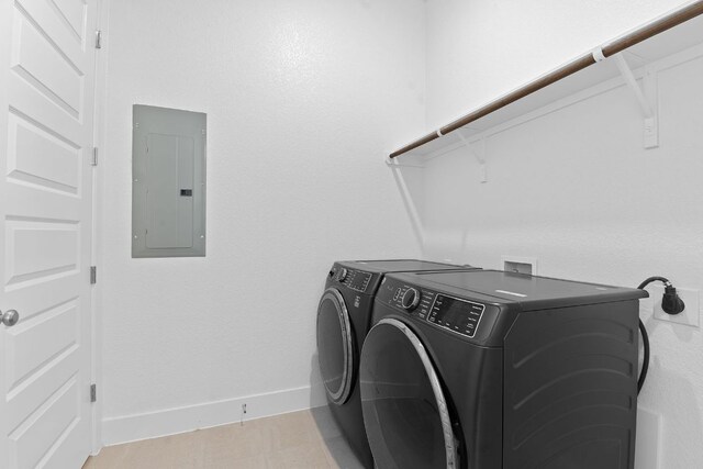 washroom with separate washer and dryer, electric panel, baseboards, and laundry area