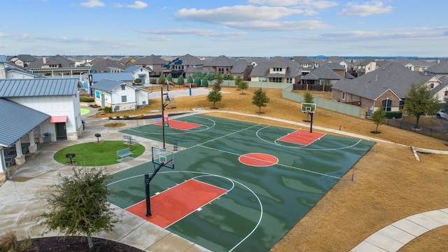 view of sport court featuring fence, community basketball court, and a residential view