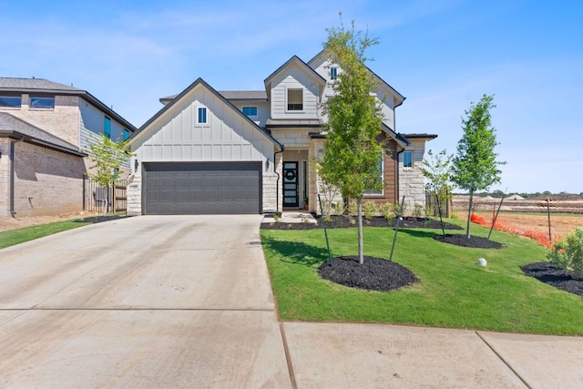 view of front of home with concrete driveway, board and batten siding, stone siding, a front yard, and a garage