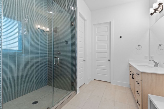 full bathroom featuring baseboards, vanity, tile patterned flooring, and a stall shower