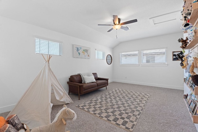 sitting room featuring attic access, carpet floors, lofted ceiling, and baseboards
