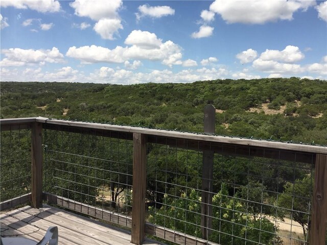 156 Lazy Leaf Ln, Wimberley, TX 78676 - wooden terrace featuring a view of trees