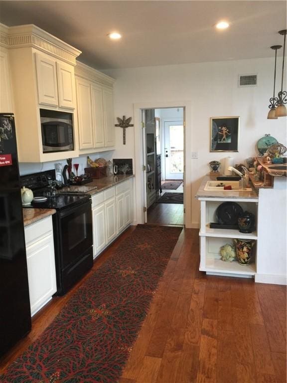 156 Lazy Leaf Ln, Wimberley, TX 78676 - kitchen featuring black appliances, dark wood-style flooring, recessed lighting, pendant lighting, and open shelves