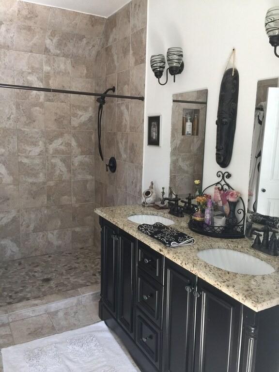 156 Lazy Leaf Ln, Wimberley, TX 78676 - bathroom with double vanity and tiled shower