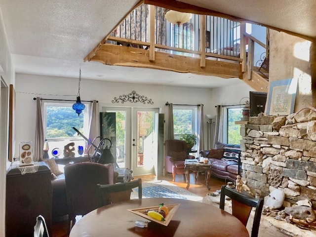 156 Lazy Leaf Ln, Wimberley, TX 78676 - living area with a textured ceiling, wood finished floors, french doors, and a towering ceiling