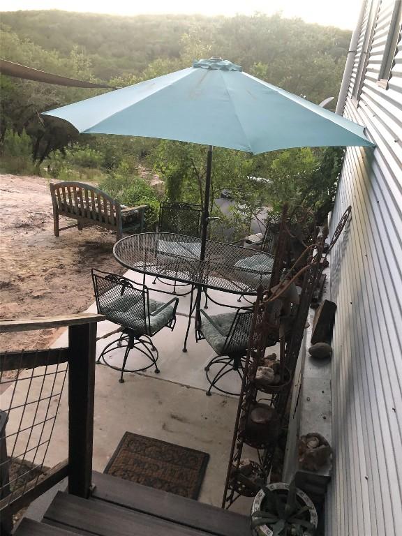 156 Lazy Leaf Ln, Wimberley, TX 78676 - wooden terrace with outdoor dining area and a patio