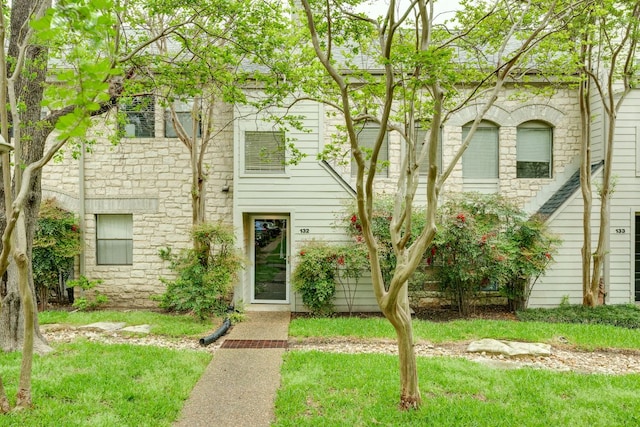 9226 Jollyville Rd Unit 132, Austin, TX 78759 - view of property featuring stone siding and a front lawn