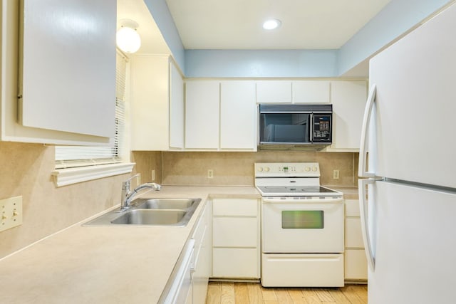 kitchen featuring a sink, white appliances, tasteful backsplash, white cabinetry, and light countertops