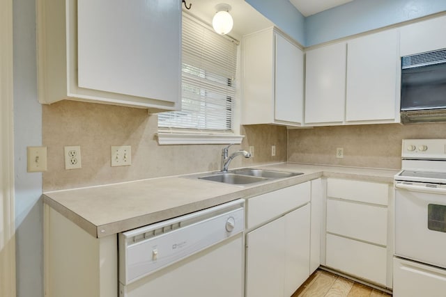 kitchen with white cabinets, white appliances, light countertops, and a sink