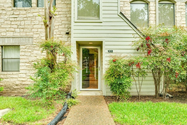 property entrance with stone siding