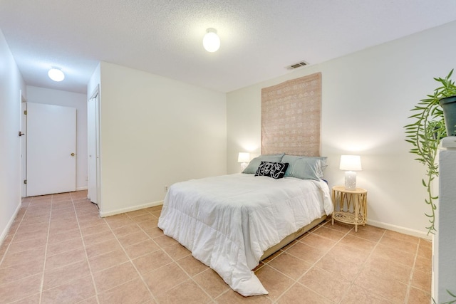 9226 Jollyville Rd Unit 132, Austin, TX 78759 - bedroom with baseboards and light tile patterned flooring
