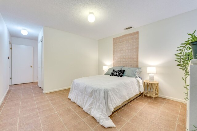 9226 Jollyville Rd Unit 132, Austin, TX 78759 - bedroom featuring baseboards and light tile patterned floors