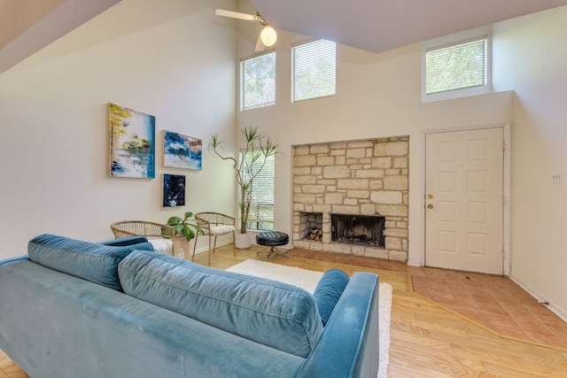 9226 Jollyville Rd Unit 132, Austin, TX 78759 - living room with high vaulted ceiling, baseboards, a stone fireplace, and a ceiling fan
