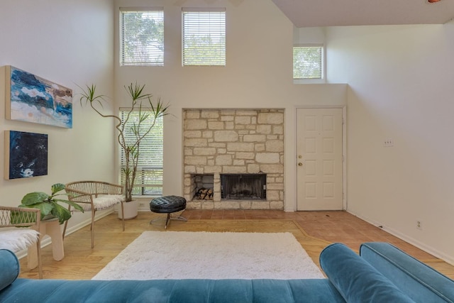 9226 Jollyville Rd Unit 132, Austin, TX 78759 - living room featuring a high ceiling, baseboards, and a fireplace
