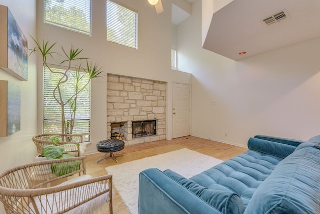 9226 Jollyville Rd Unit 132, Austin, TX 78759 - living area with a towering ceiling, plenty of natural light, a fireplace, and wood finished floors