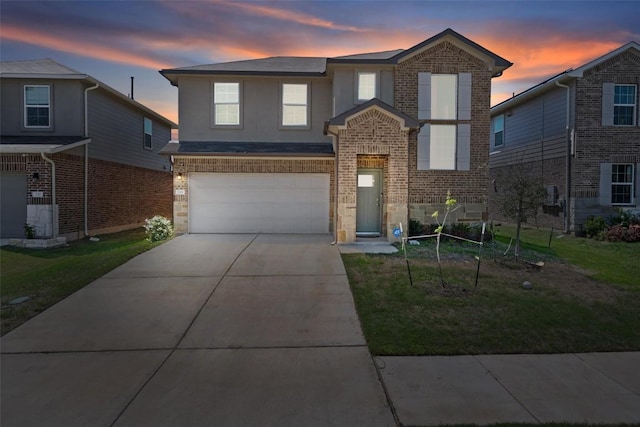 traditional-style home featuring driveway, stucco siding, brick siding, and a garage