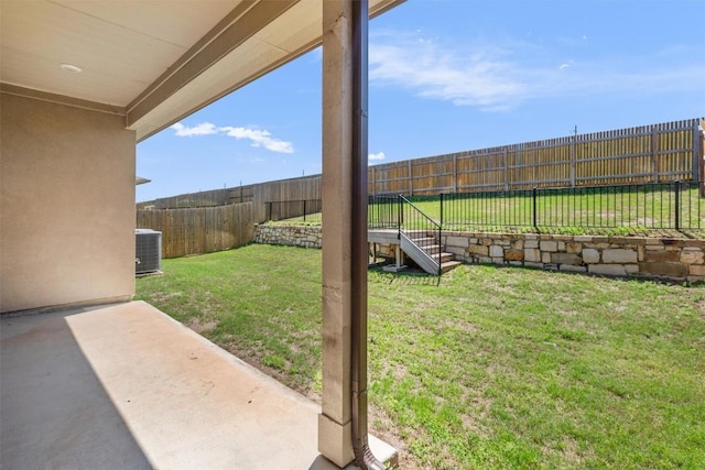 view of yard featuring a fenced backyard, a patio area, and cooling unit