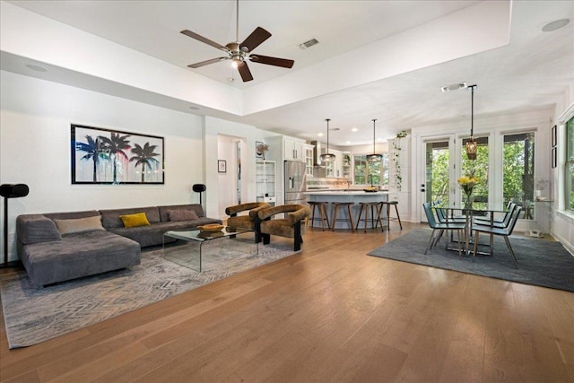 living area featuring recessed lighting, visible vents, ceiling fan, and wood finished floors