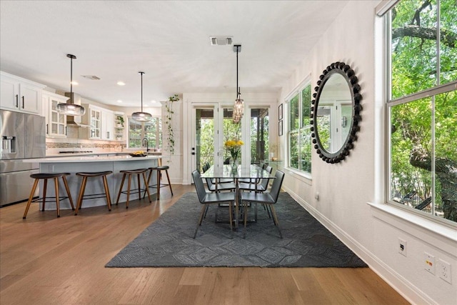 15213 Falconhead Grove Loop, Austin, TX 78738 - dining room with dark wood-style flooring, healthy amount of natural light, baseboards, and recessed lighting