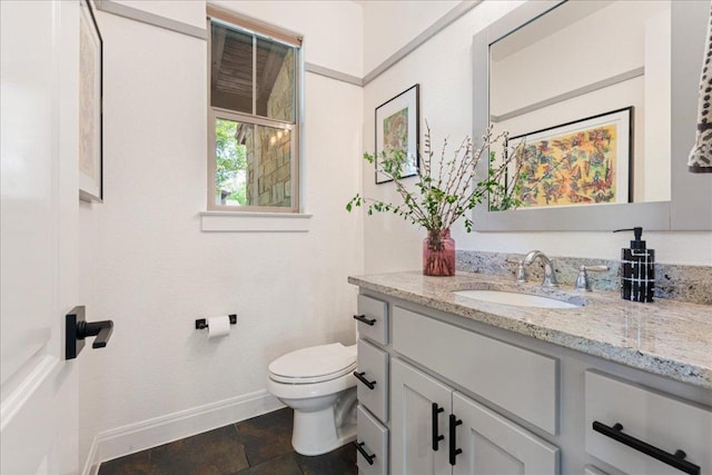 15213 Falconhead Grove Loop, Austin, TX 78738 - bathroom featuring baseboards, vanity, toilet, and stone finish flooring