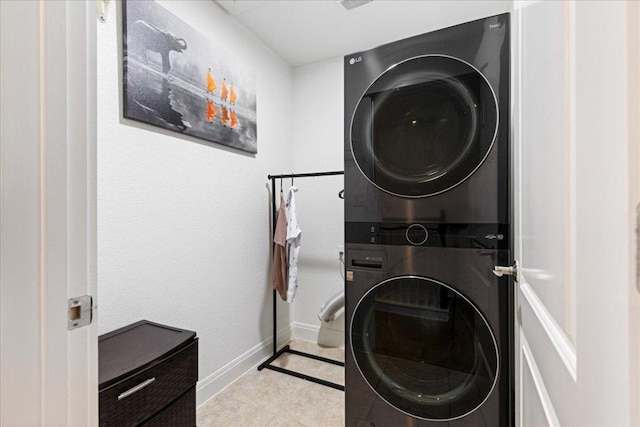 15213 Falconhead Grove Loop, Austin, TX 78738 - laundry room featuring stacked washer / dryer, light tile patterned flooring, and baseboards
