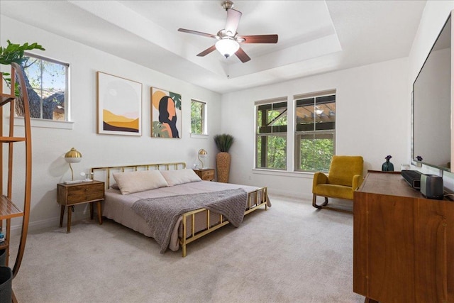 15213 Falconhead Grove Loop, Austin, TX 78738 - bedroom featuring light carpet, a tray ceiling, baseboards, and ceiling fan