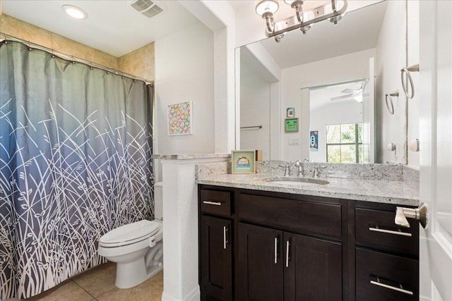 15213 Falconhead Grove Loop, Austin, TX 78738 - full bathroom featuring tile patterned floors, toilet, vanity, and ceiling fan