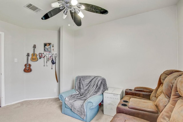 living area featuring carpet floors, visible vents, baseboards, and ceiling fan