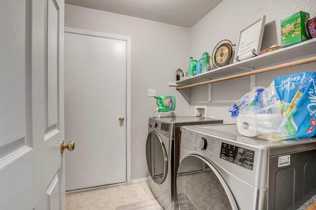laundry area featuring separate washer and dryer, baseboards, and laundry area