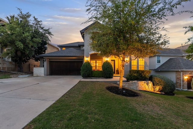 3817 Benetton Way, Leander, TX 78641 - view of front of home with stucco siding, an attached garage, a front yard, and driveway
