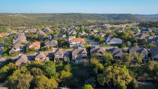 3817 Benetton Way, Leander, TX 78641 - aerial view of property and surrounding area featuring nearby suburban area and a mountainous background