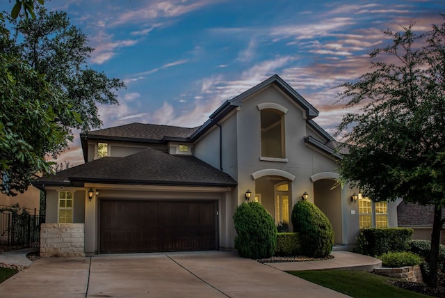 3817 Benetton Way, Leander, TX 78641 - view of front of property featuring concrete driveway, an attached garage, stucco siding, and a shingled roof