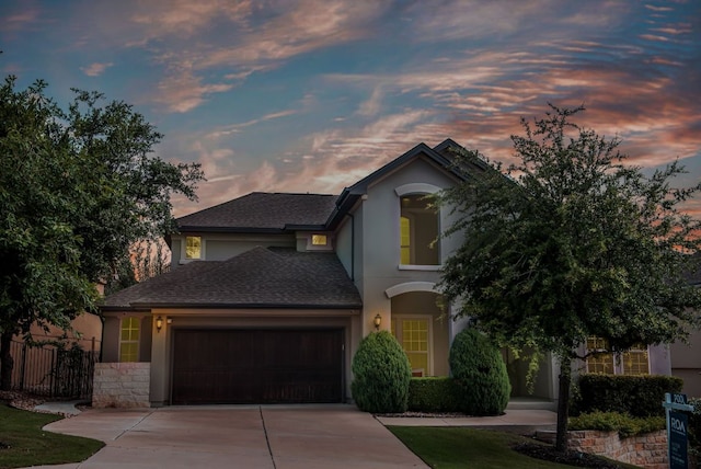 3817 Benetton Way, Leander, TX 78641 - traditional-style house with driveway, an attached garage, stucco siding, and roof with shingles