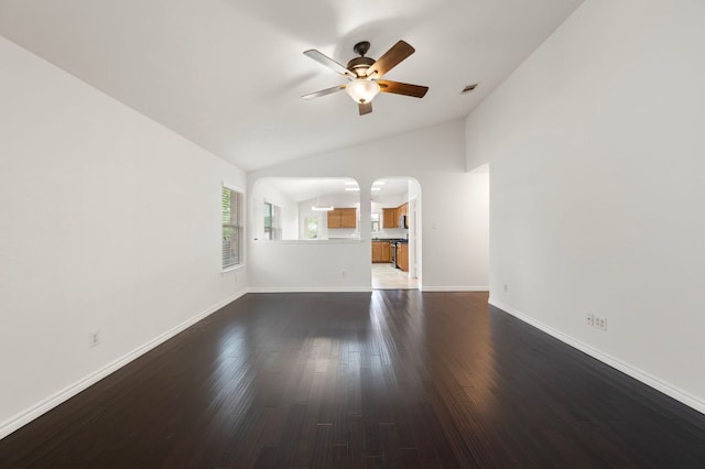 unfurnished living room with ceiling fan, arched walkways, visible vents, dark wood-style flooring, and lofted ceiling