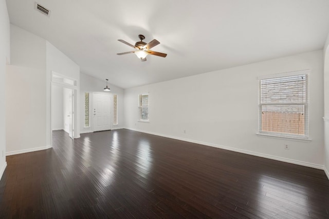 unfurnished living room with dark wood-type flooring, visible vents, a ceiling fan, and plenty of natural light