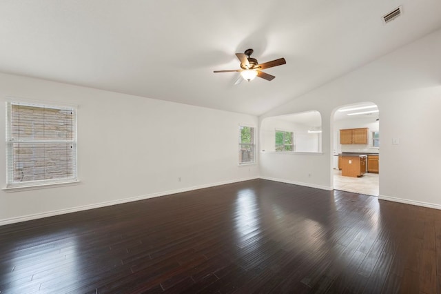 interior space featuring visible vents, dark wood-style flooring, a ceiling fan, and lofted ceiling
