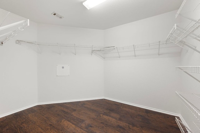 walk in closet with visible vents and wood finished floors