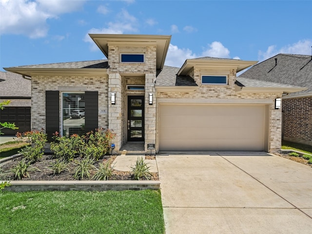 view of front of house featuring a garage, a shingled roof, driveway, stone siding, and brick siding