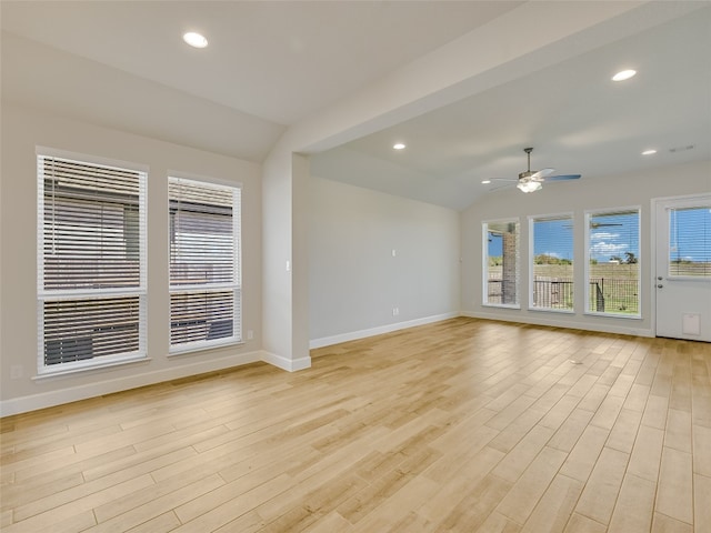 unfurnished room with light wood-style flooring, baseboards, visible vents, a ceiling fan, and lofted ceiling