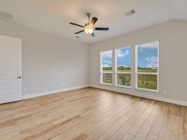 unfurnished room with baseboards, visible vents, ceiling fan, and light wood finished floors